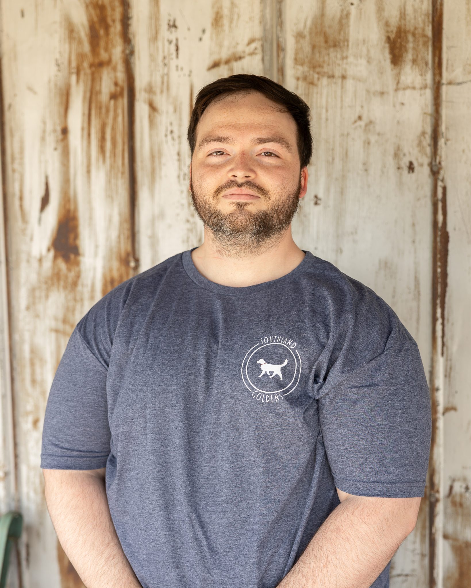 a man with a beard and mustache wearing a grey shirt